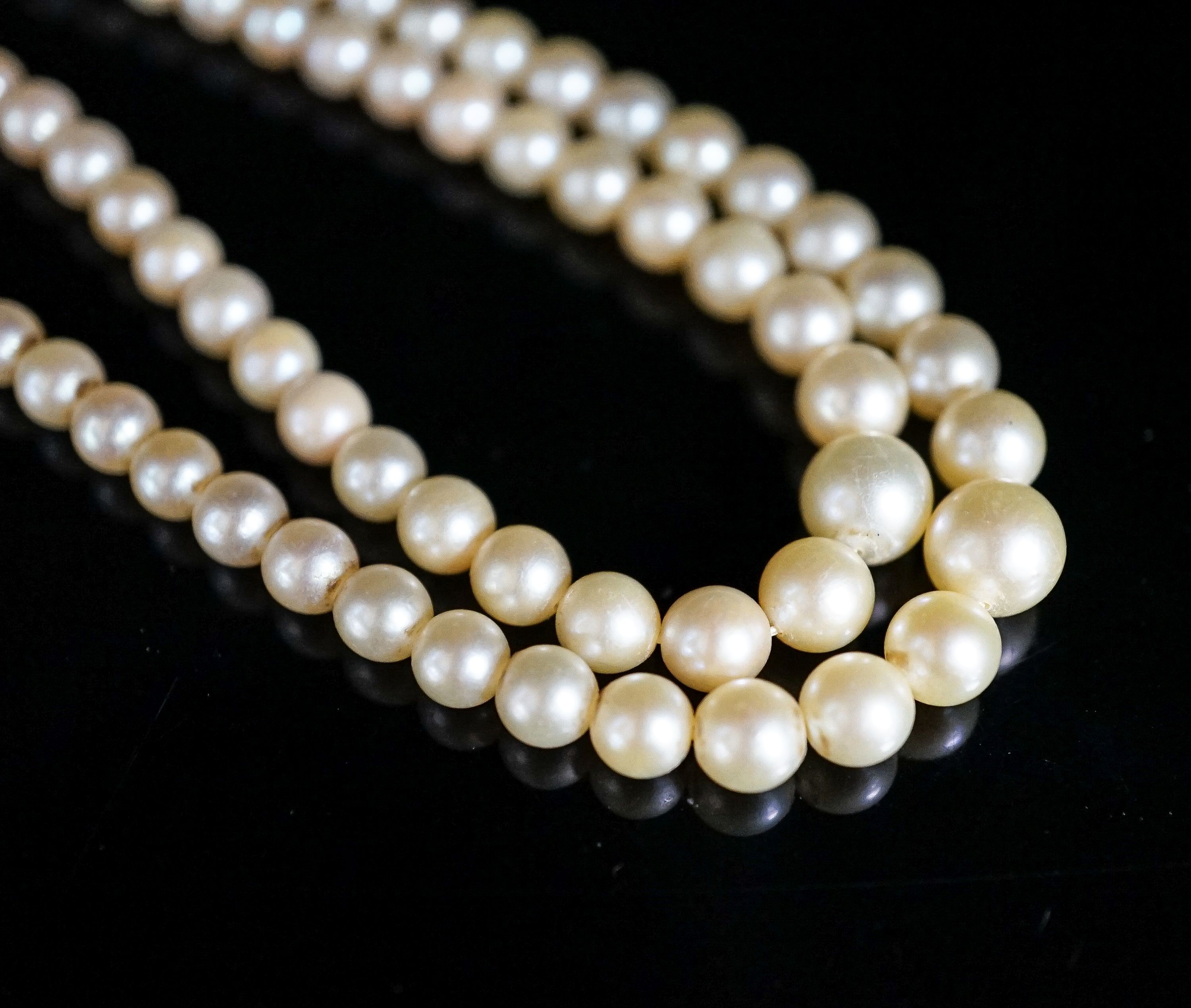 A double strand graduated cultured pearl choker necklace, with three stone diamond set clasp, 39cm.